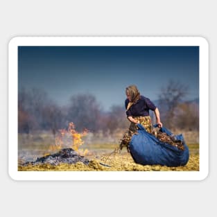 Senior rural woman burning fallen leaves Sticker